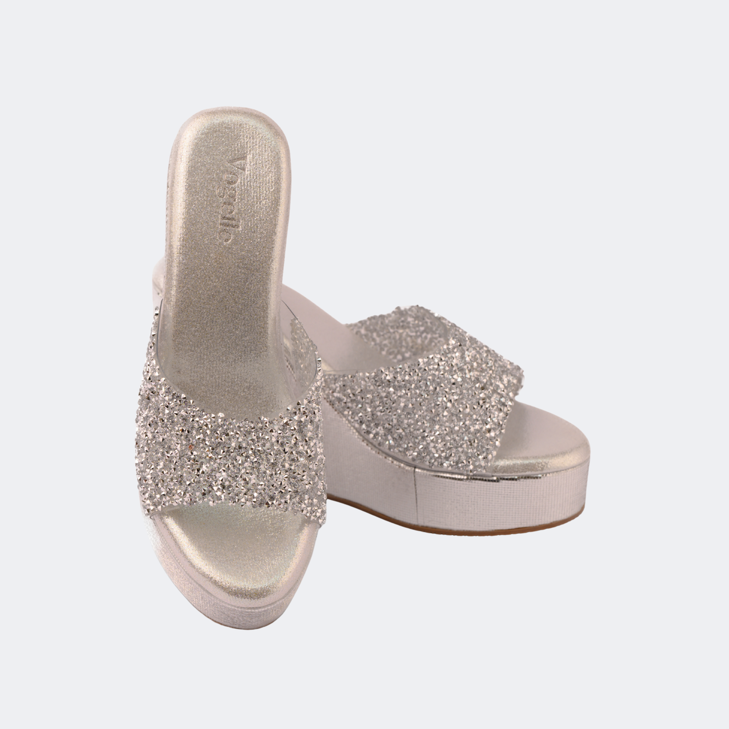 Silver glittery sandals on a light gray background | Vogelle