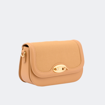 Tan handbag with gold clasp on a light gray background | Vogelle
