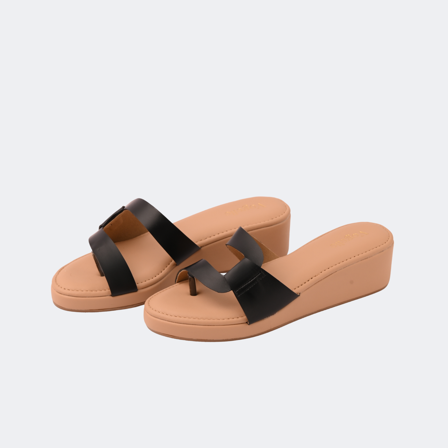 Tan sandals with black straps on a light gray background | Vogelle