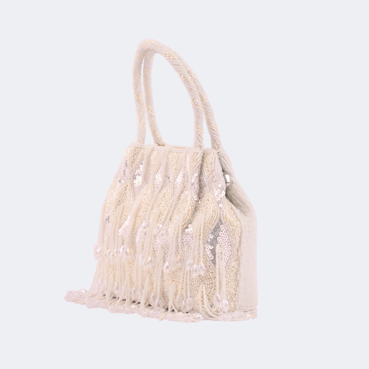 Beige handbag with fringe details on a light gray background | Vogelle