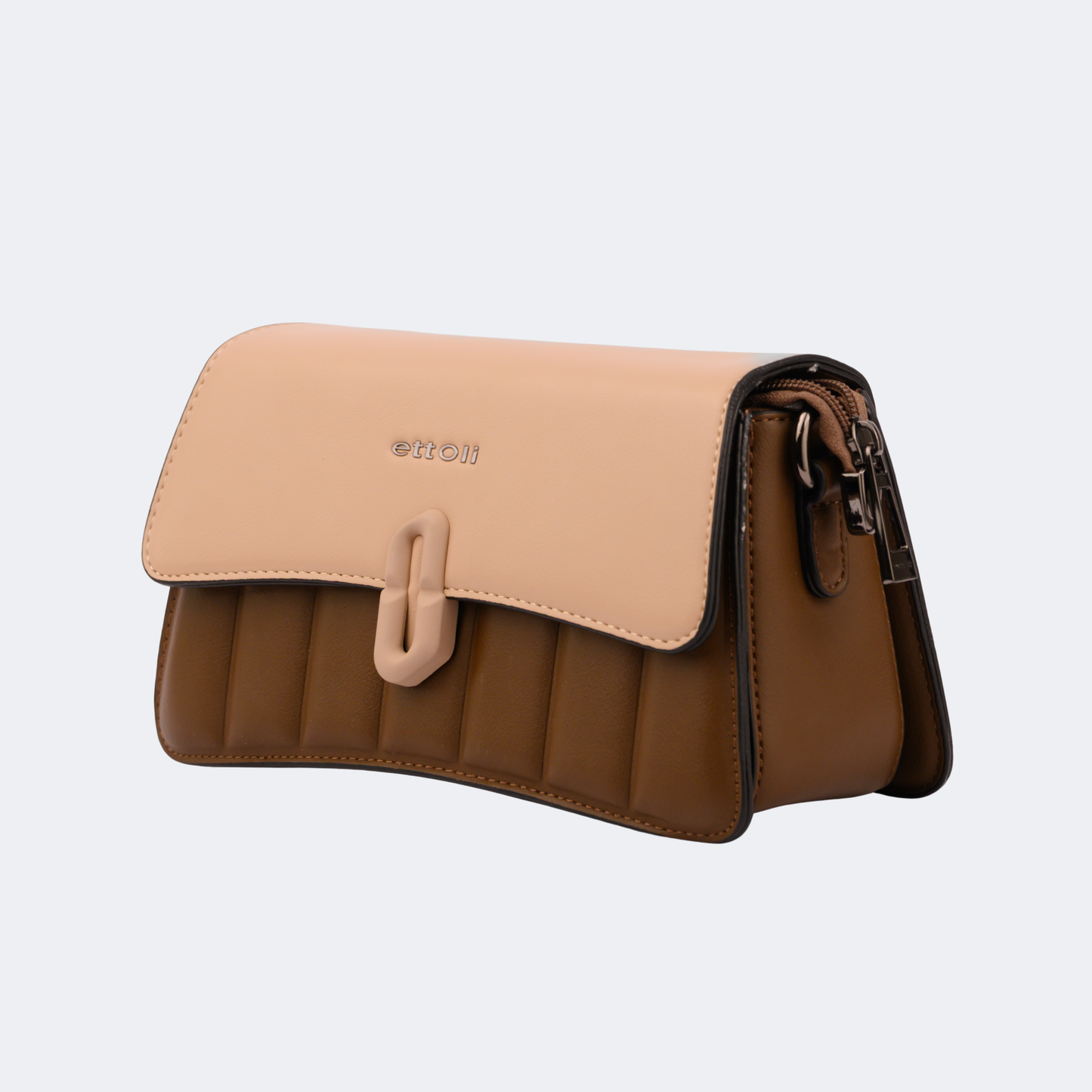 Two-tone handbag with beige top section and brown bottom section on a light gray background | Vogelle