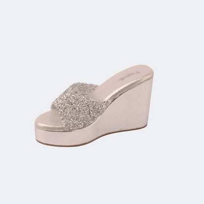 Wedge sandal with glittery strap on a light gray background | Vogelle