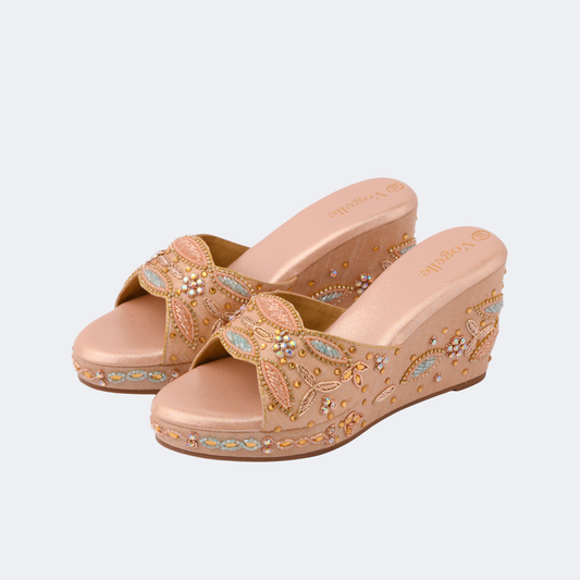 Pair of beige wedge sandals with decorative patterns on a light gray background | Vogelle