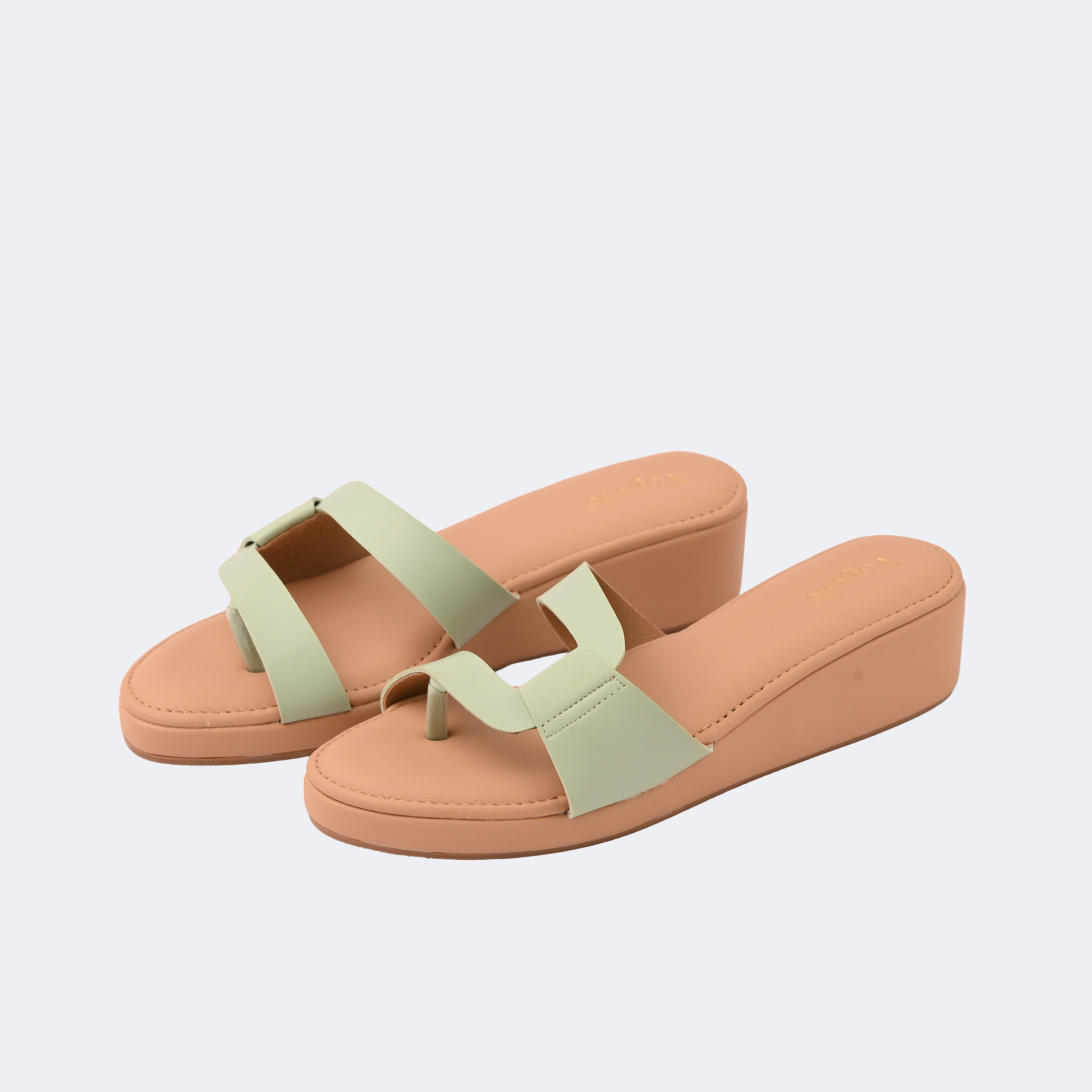 Pair of tan sandals with green straps on a light gray background | Vogelle