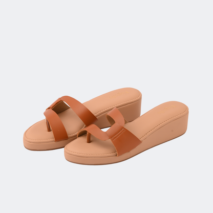 Pair of tan sandals with brown straps on a light gray background | Vogelle